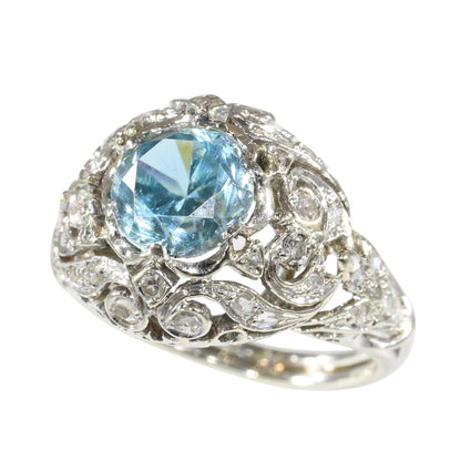 A round blue zircon and diamond openwork ring in platinum