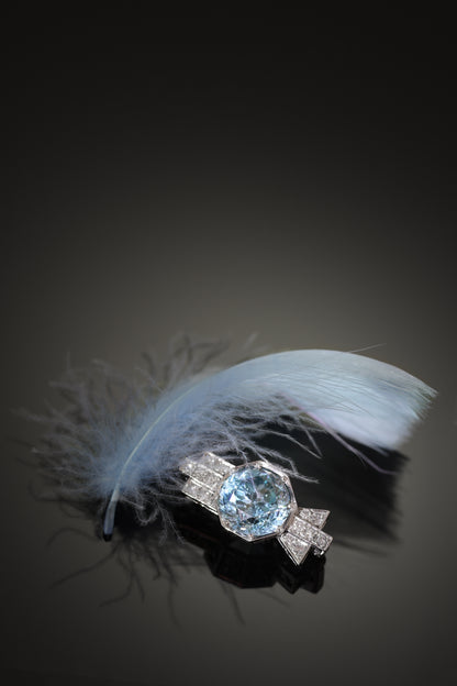 A blue zircon and diamond geometric designed brooch in platinum, with a blue feather