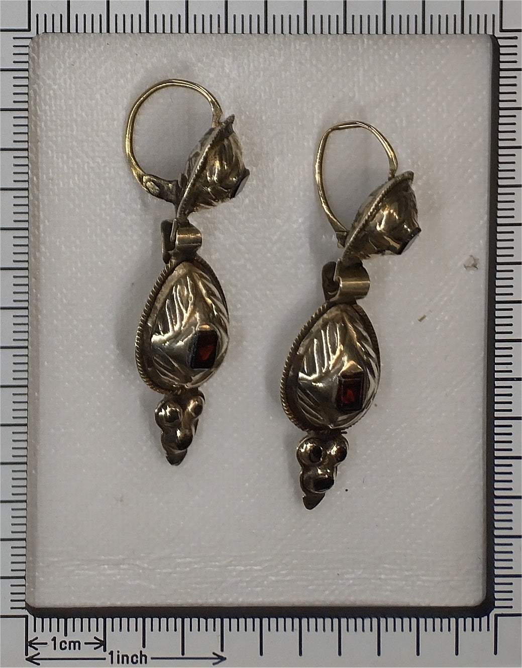 A pair of antique yellow gold double drop earrings with garnets, with a ruler