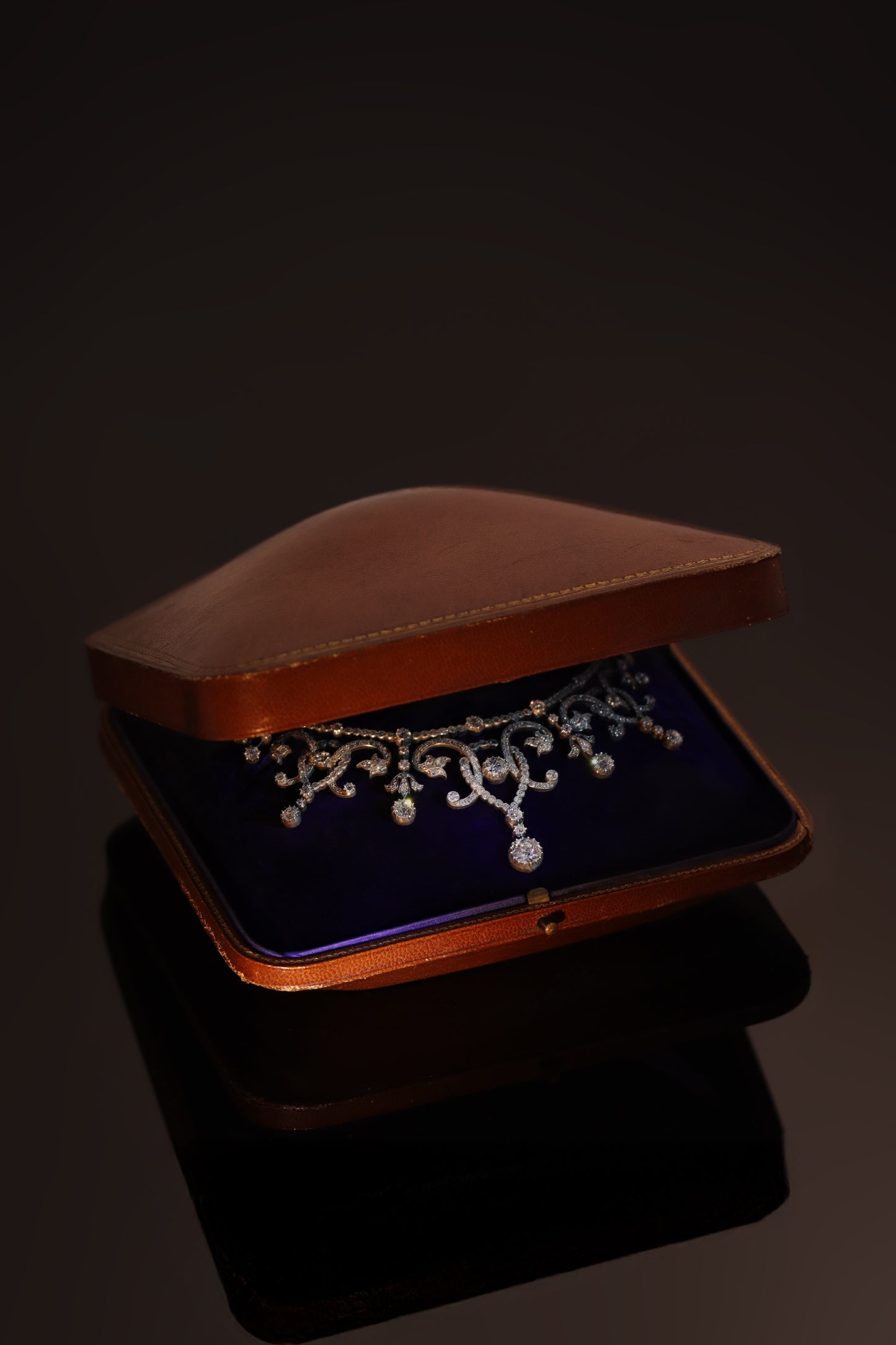 An intricate diamond fringe collar necklace with diamond pendant drops, in an antique box
