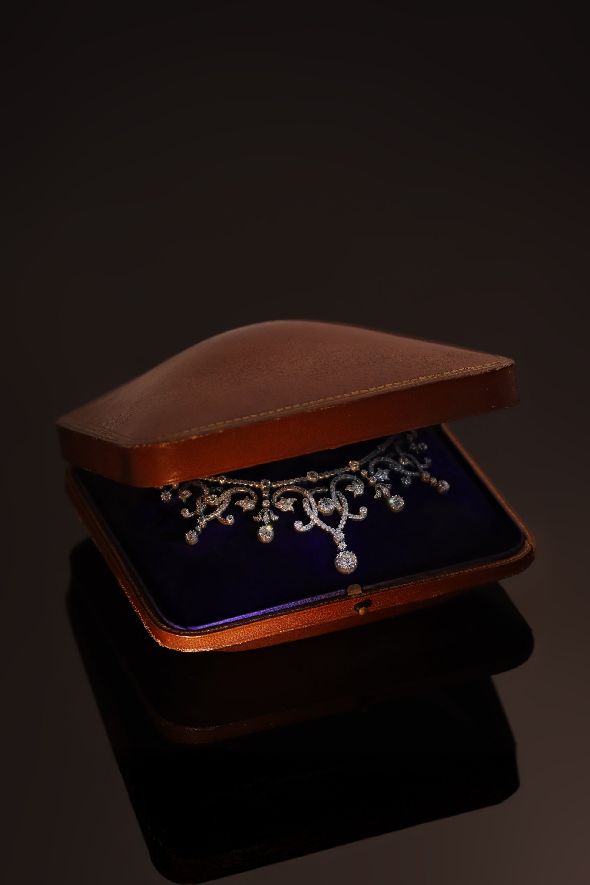An intricate diamond fringe collar necklace with diamond pendant drops, in an antique box