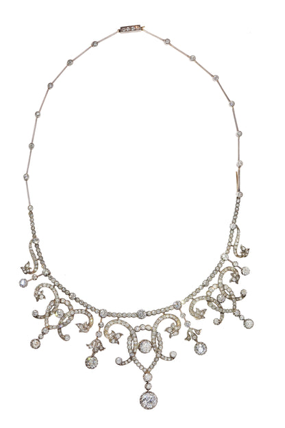 An intricate diamond fringe collar necklace with diamond pendant drops
