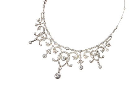 An intricate diamond fringe collar necklace with diamond pendant drops