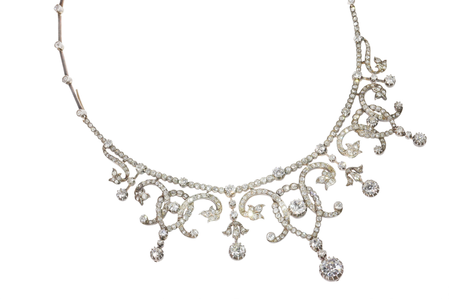 An intricate diamond fringe collar necklace with diamond pendant drops