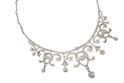 An intricate diamond fringe collar necklace with diamond pendant drops