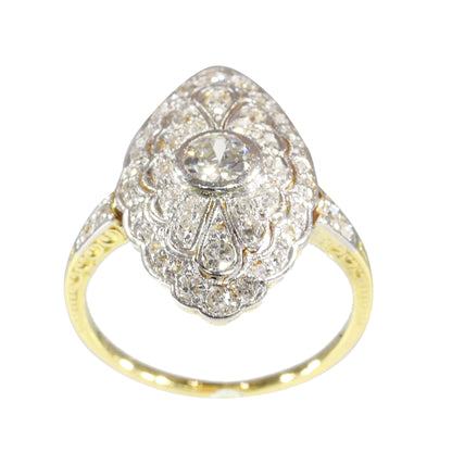 A navette shaped cluster ring set with diamonds in yellow and white gold