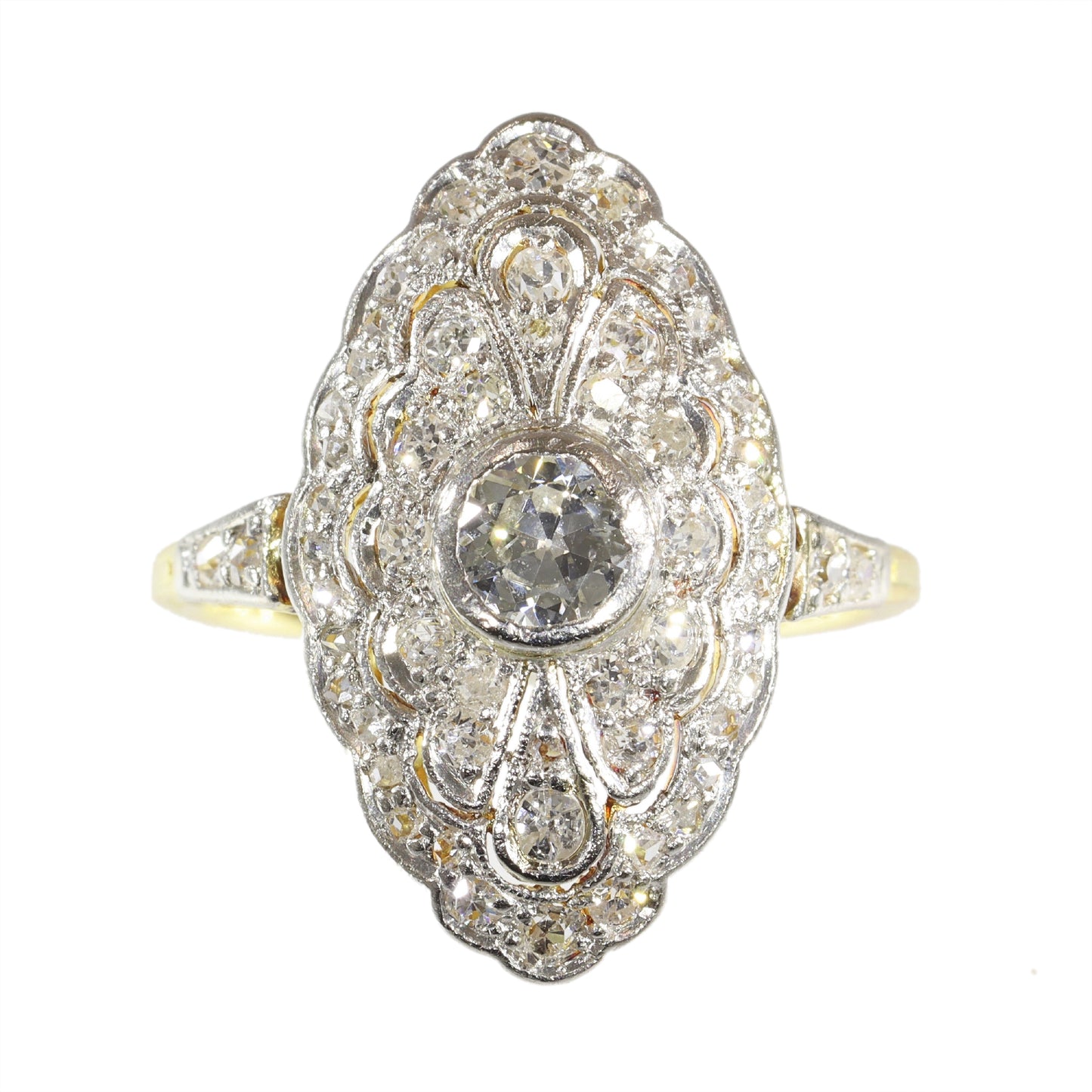A navette shaped cluster ring set with diamonds in yellow and white gold