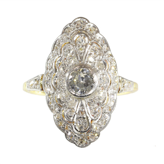 A navette shaped cluster ring set with diamonds in yellow and white gold