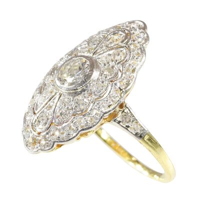 A navette shaped cluster ring set with diamonds in yellow and white gold