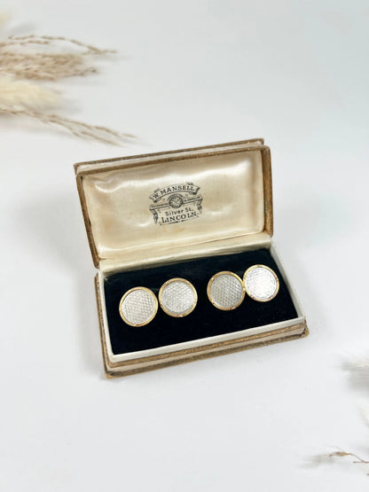 A pair of circular platinum and yellow gold cufflinks, in an antique box