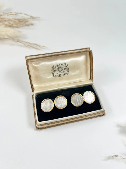 A pair of circular platinum and yellow gold cufflinks, in an antique box