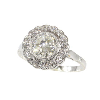A brilliant cut diamond scalloped edge cluster ring in platinum