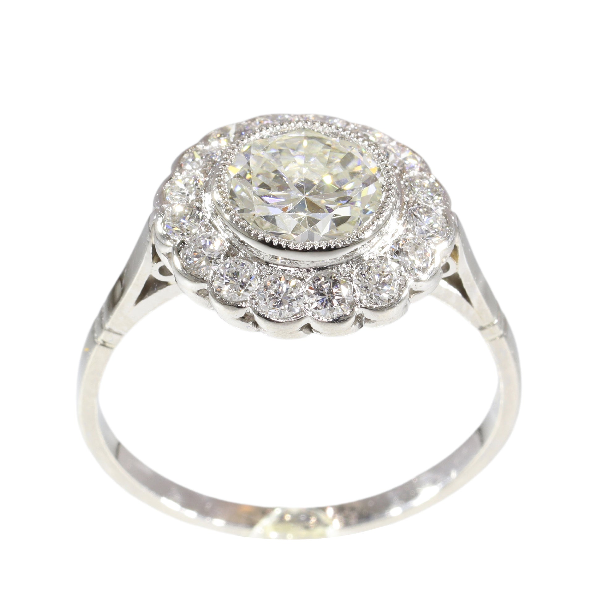 A brilliant cut diamond scalloped edge cluster ring in platinum