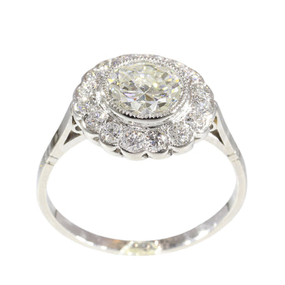 A brilliant cut diamond scalloped edge cluster ring in platinum