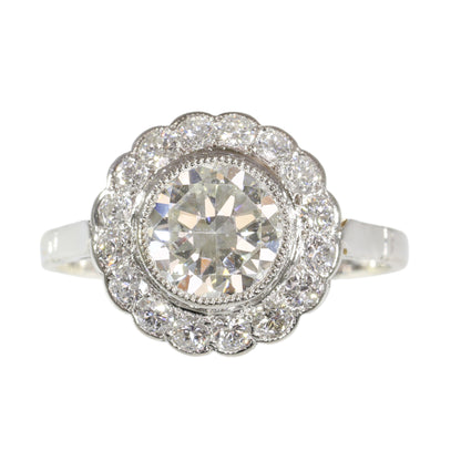 A brilliant cut diamond scalloped edge cluster ring in platinum