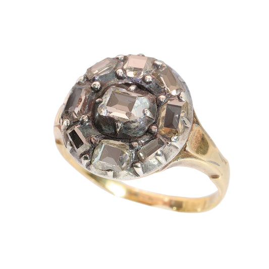An antique circular cluster ring with table cut diamonds, in gold and silver