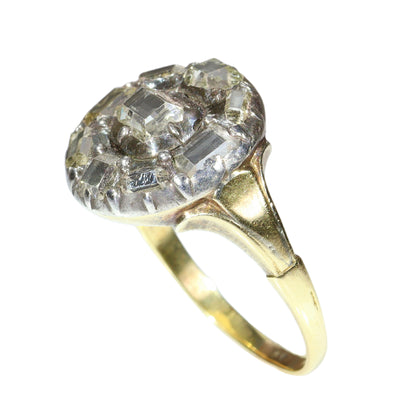 An antique circular cluster ring with table cut diamonds, in gold and silver
