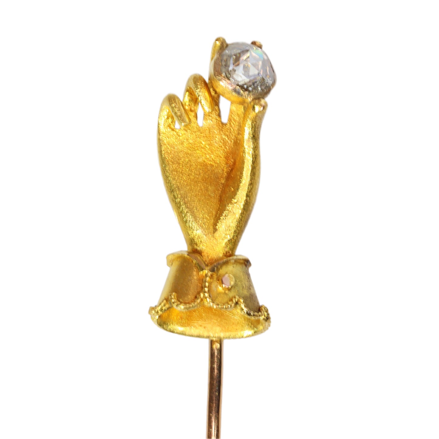 A yellow gold hand holding a diamond stick or tie pin