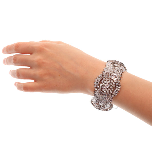 A fine diamond geometric bracelet in platinum, modelled on a wrist