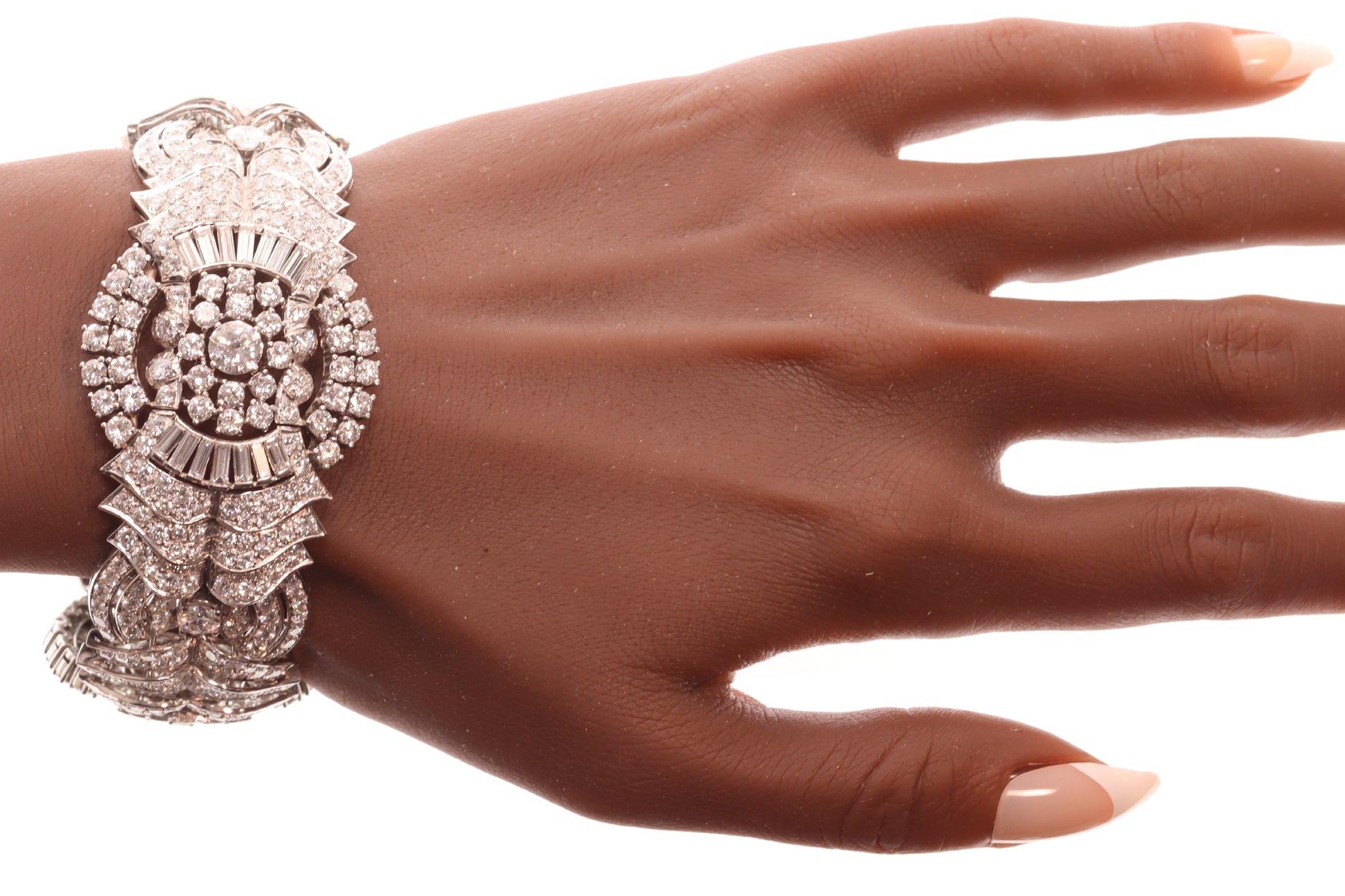 A fine diamond geometric bracelet in platinum, modelled on a wrist