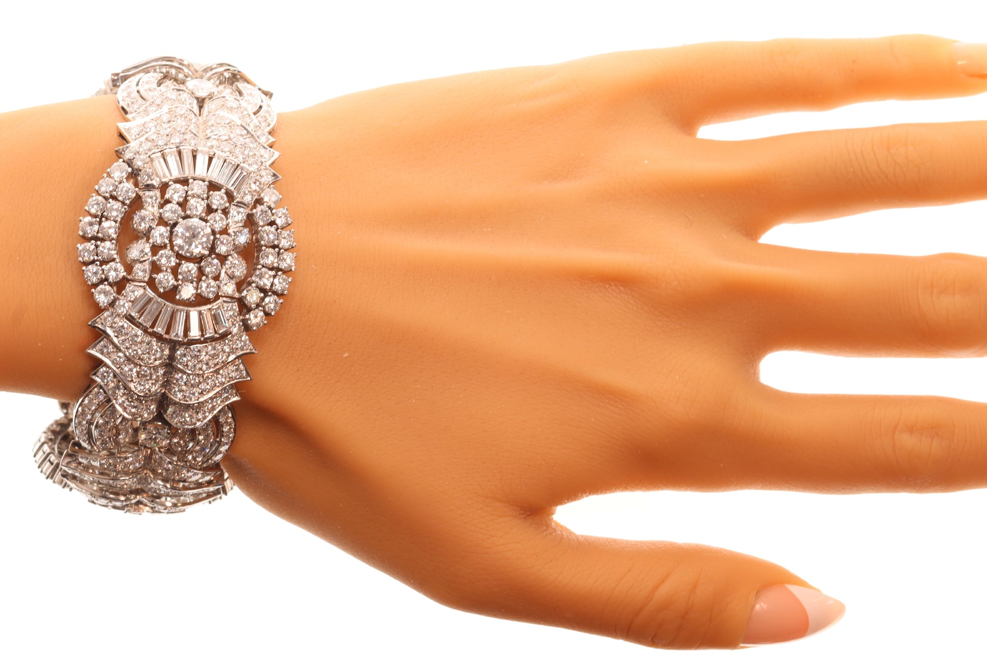 A fine diamond geometric bracelet in platinum, modelled on a wrist
