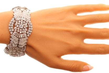 A fine diamond geometric bracelet in platinum, modelled on a wrist