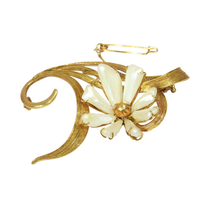 An antique yellow gold flower brooch with elongated white pearls