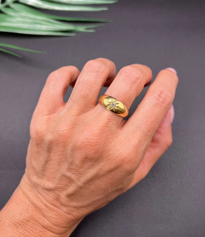 A single stone old cut diamond gypsy band ring in yellow gold, modelled on a hand