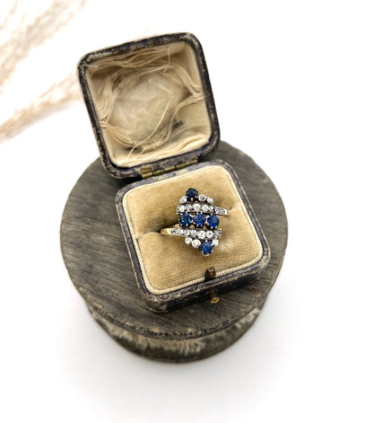 A navette shaped sapphire and diamond ring in yellow gold, in an antique ring box