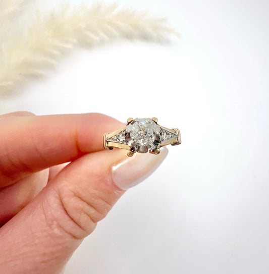 A single stone diamond ring in yellow gold and platinum