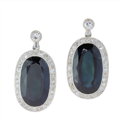A pair of oval sapphire and diamond cluster drop earrings
