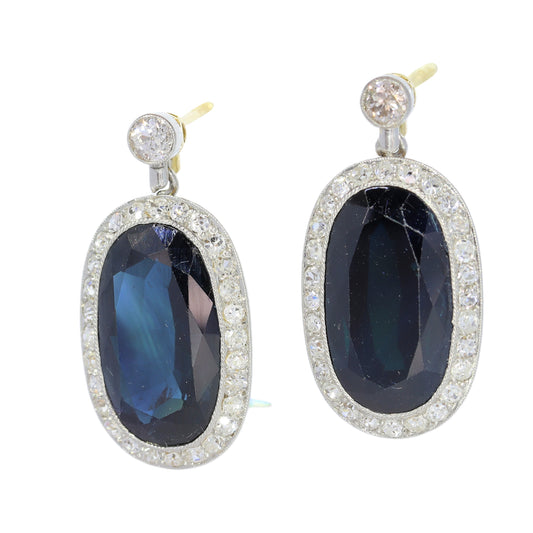 A pair of oval sapphire and diamond cluster drop earrings