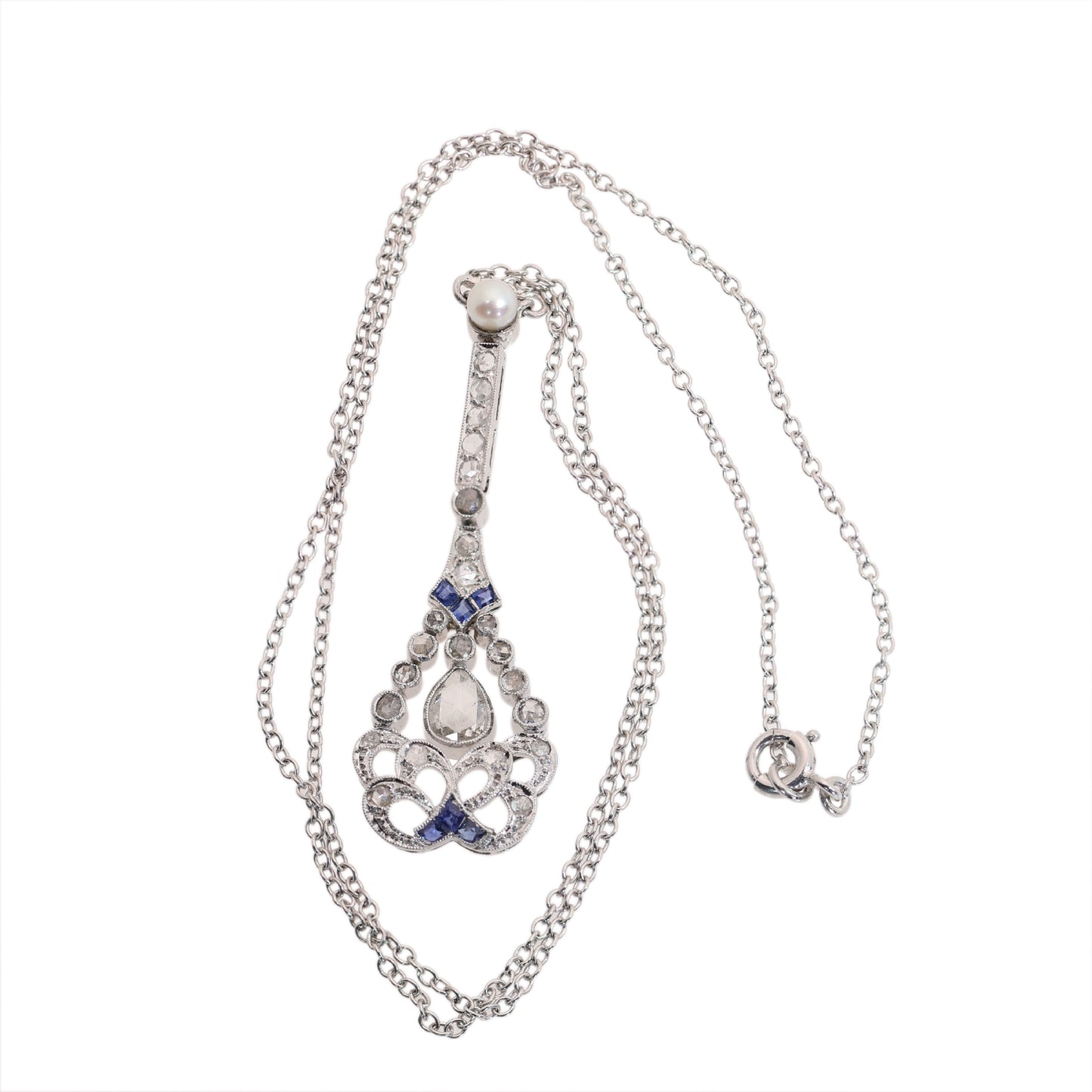 A diamond, sapphire and pearl drop pendant necklace in platinum