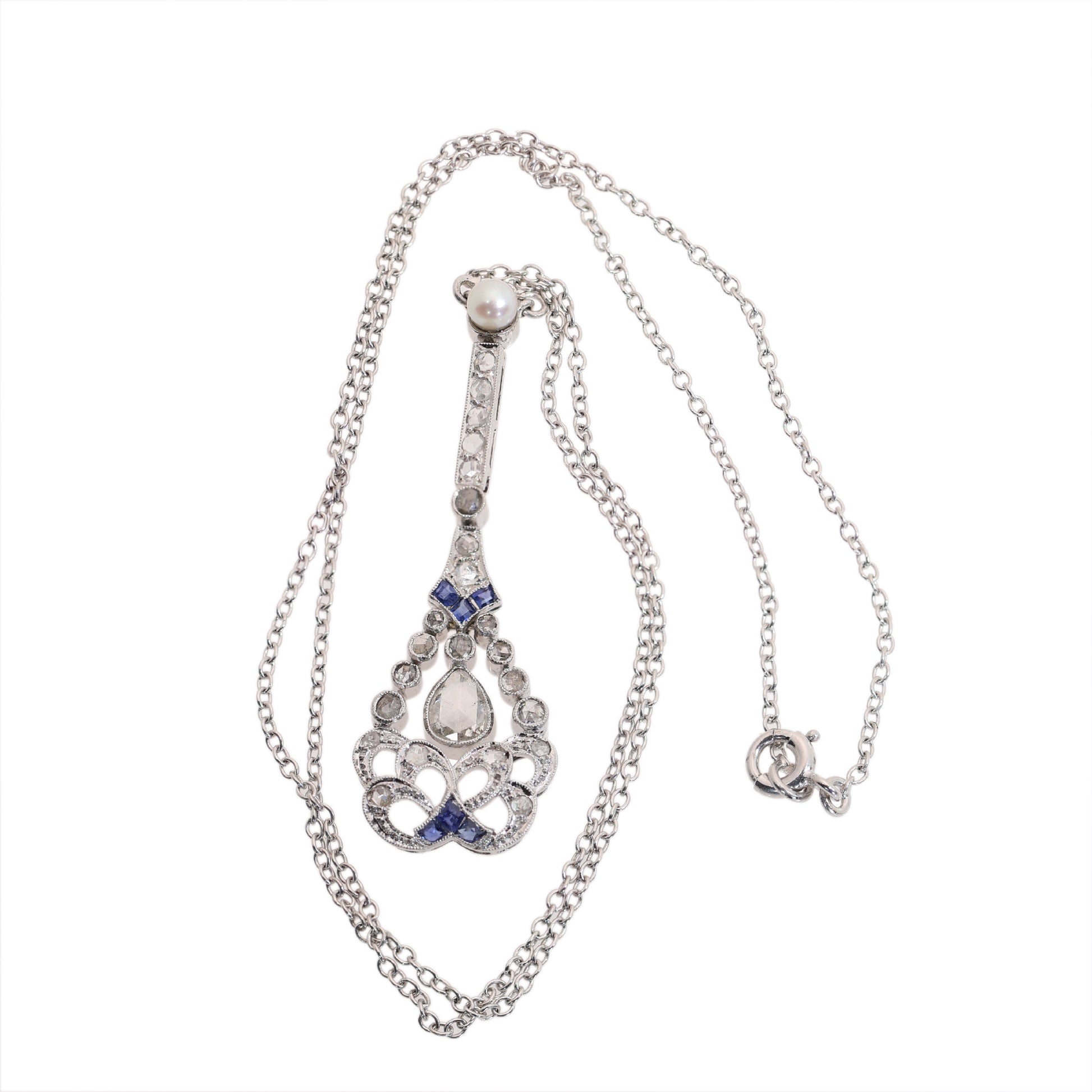 A diamond, sapphire and pearl drop pendant necklace in platinum