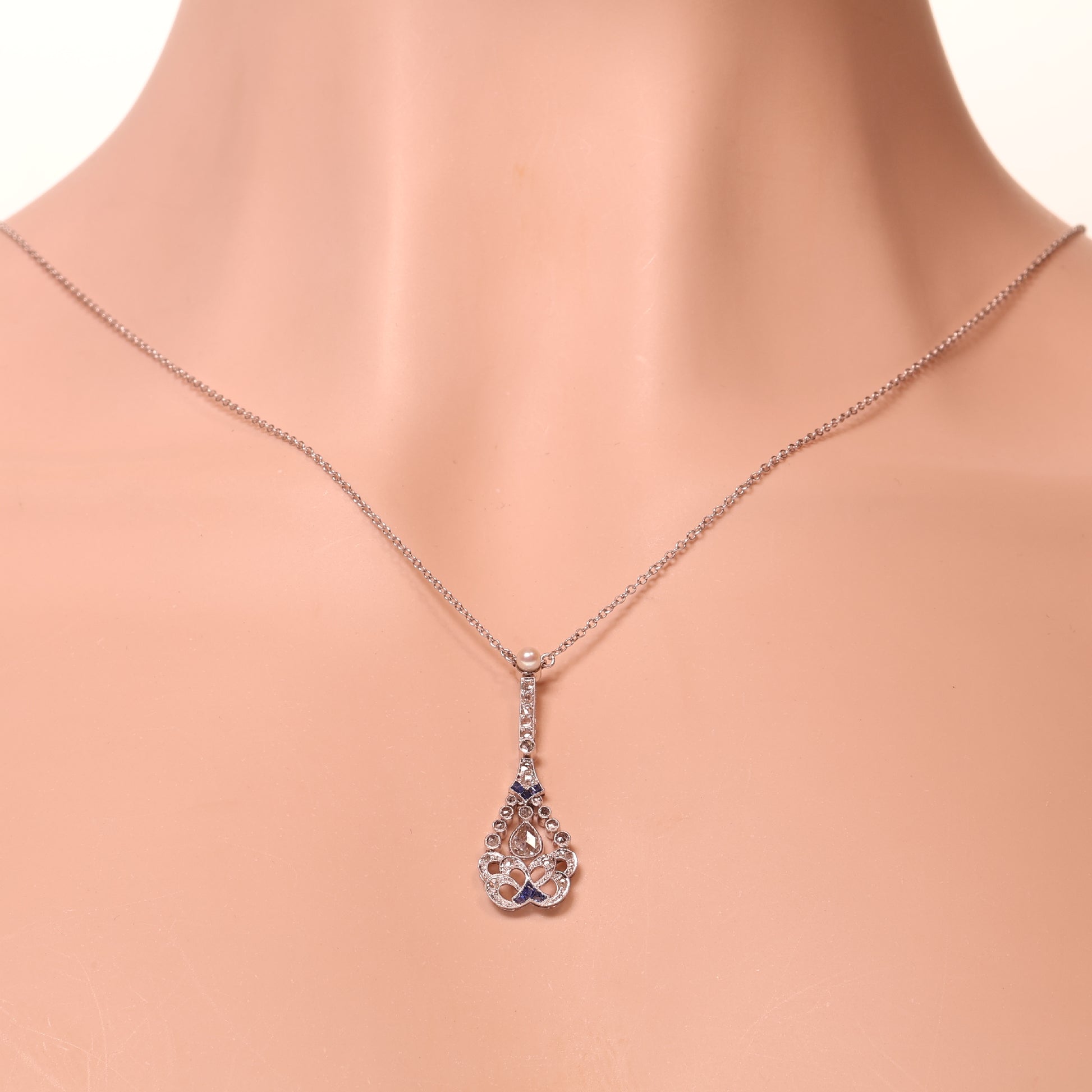 A diamond, sapphire and pearl drop pendant necklace in platinum, modelled on a neck