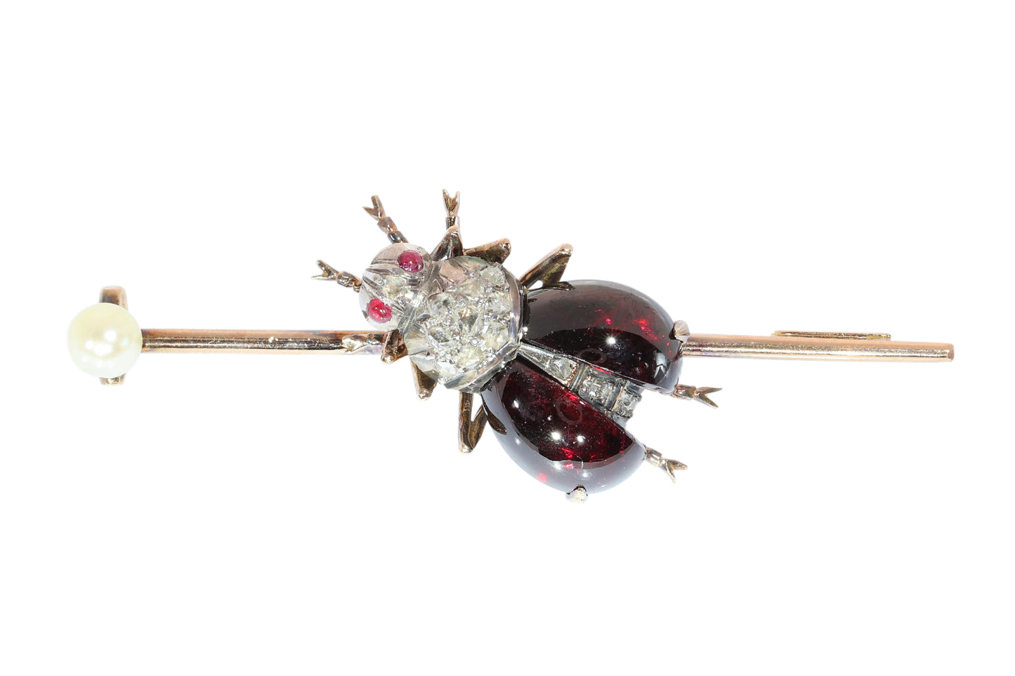 An antique gold bar brooch with a diamond, garnet and ruby set insect in the centre