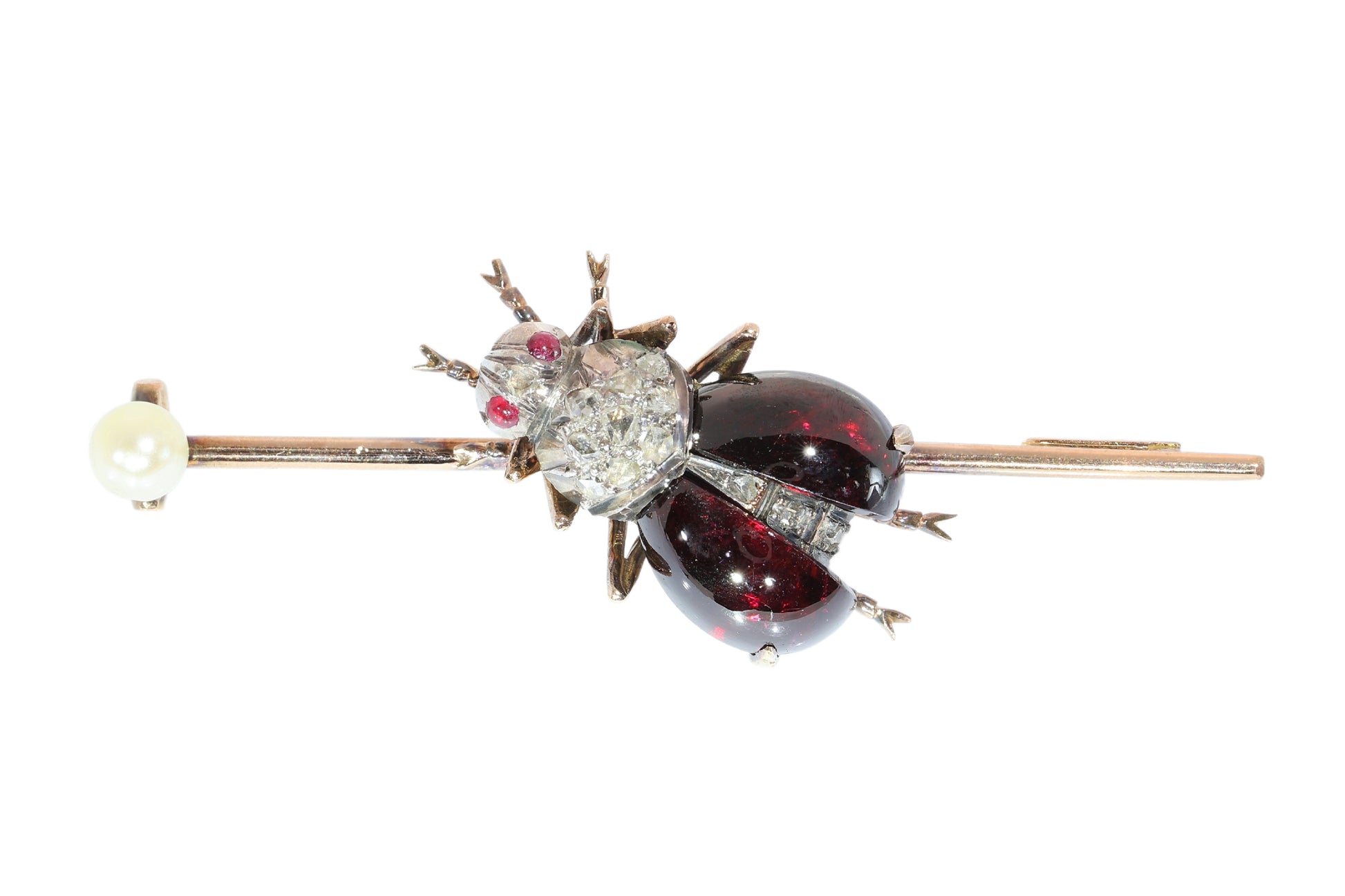 An antique gold bar brooch with a diamond, garnet and ruby set insect in the centre