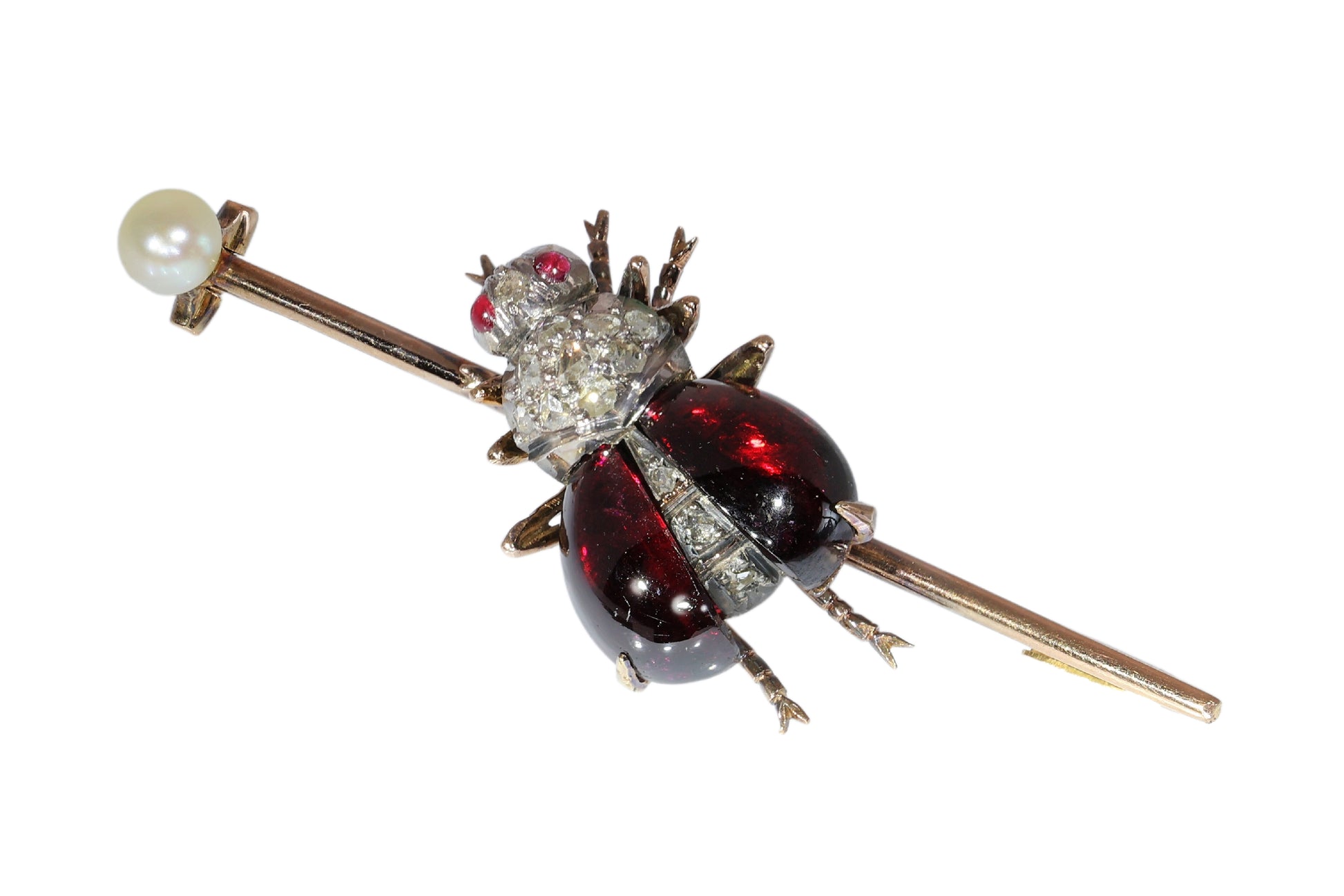 An antique gold bar brooch with a diamond, garnet and ruby set insect in the centre