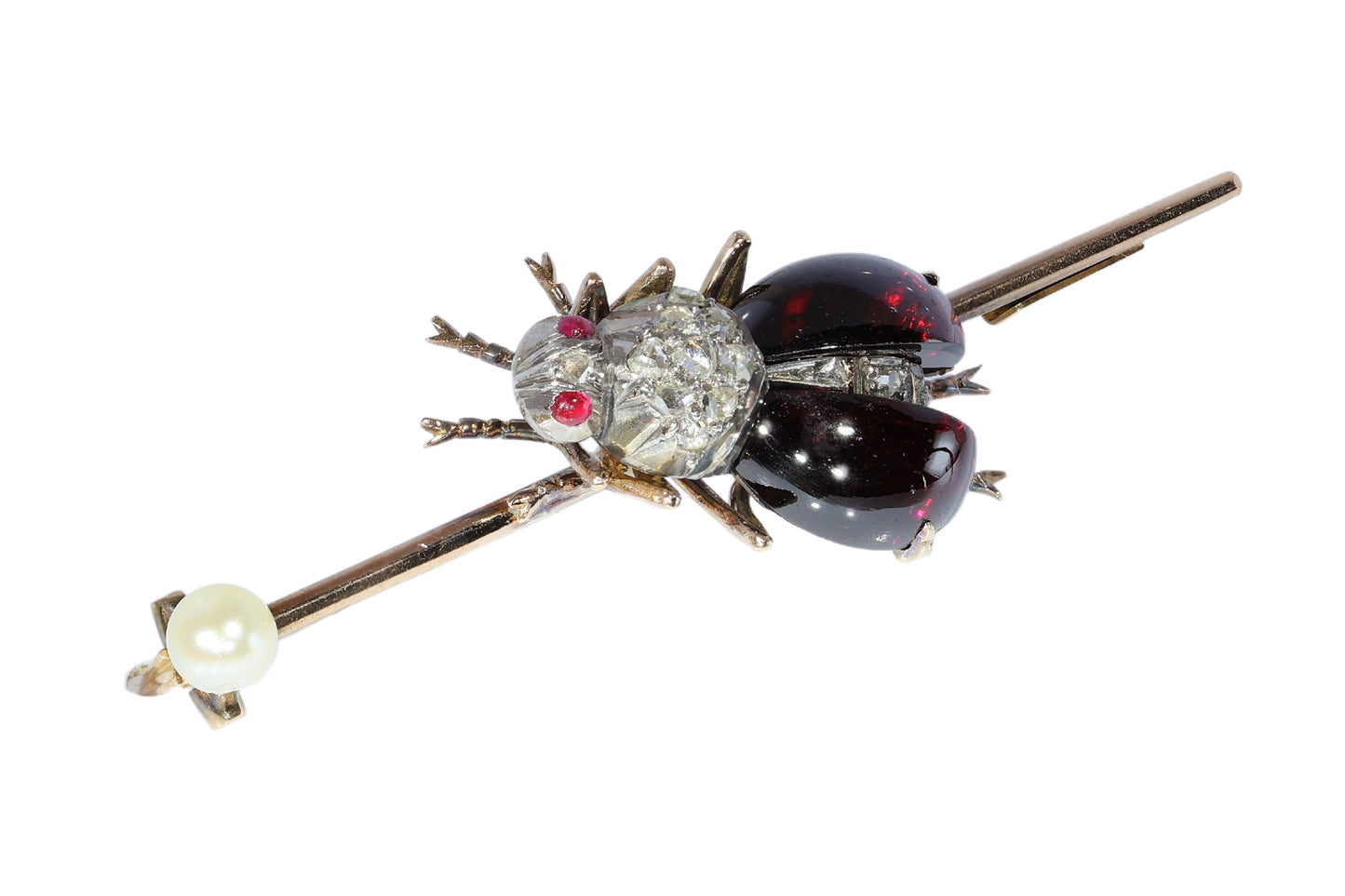 An antique gold bar brooch with a diamond, garnet and ruby set insect in the centre