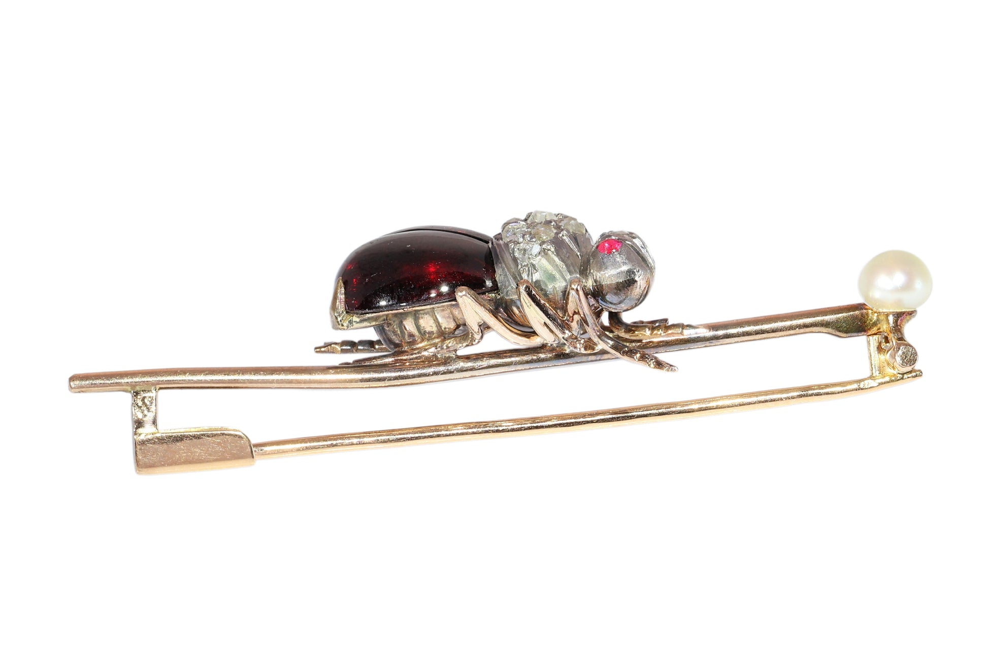An antique gold bar brooch with a diamond, garnet and ruby set insect in the centre