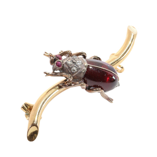 A garnet, ruby and diamond beetle brooch in gold and silver