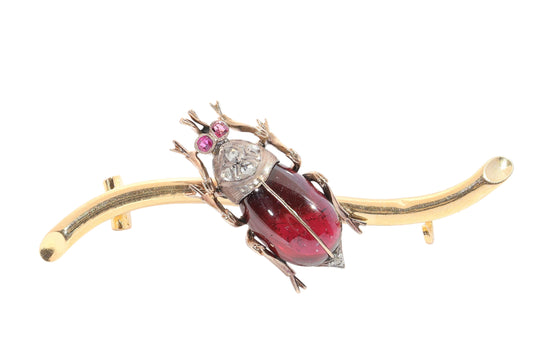 A garnet, ruby and diamond beetle brooch in gold and silver
