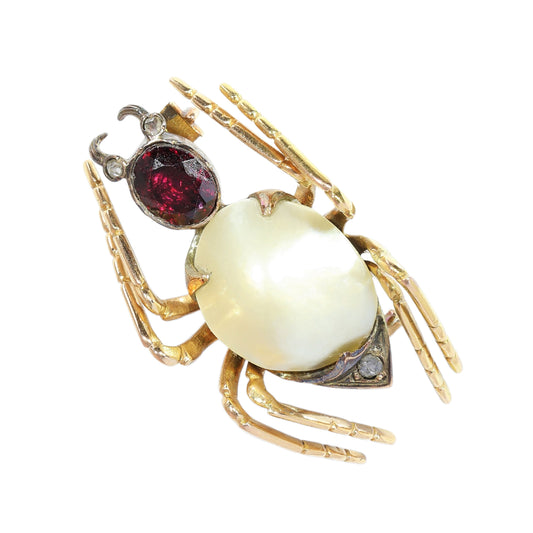 A spider brooch in gold and silver, with a pearl, garnet and diamond body