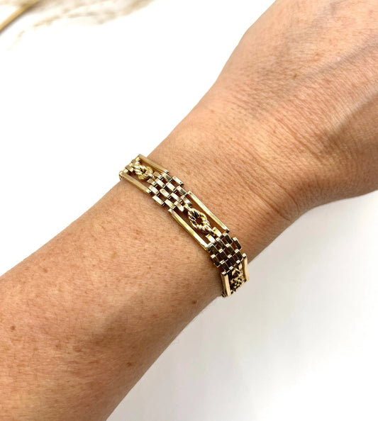 A yellow gold gate bracelet, modelled on a wrist
