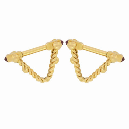 A pair of yellow gold ruby cufflinks, on a white background