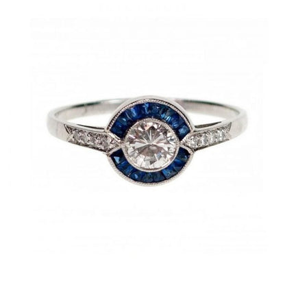 Vintage Art Deco Style Sapphire, Diamond and Platinum Target Cluster Ring; 0.40ct round brilliant-cut diamond surrounded by 0.60cts calibre-cut sapphires