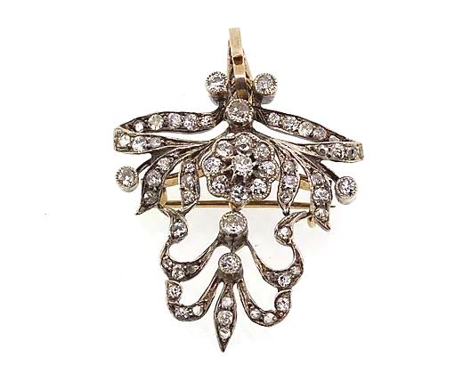 Art Nouveau Diamond set Brooch Pendant; a pendant come brooch with diamond set floral cluster, bow and swag detailing. Set in silver.