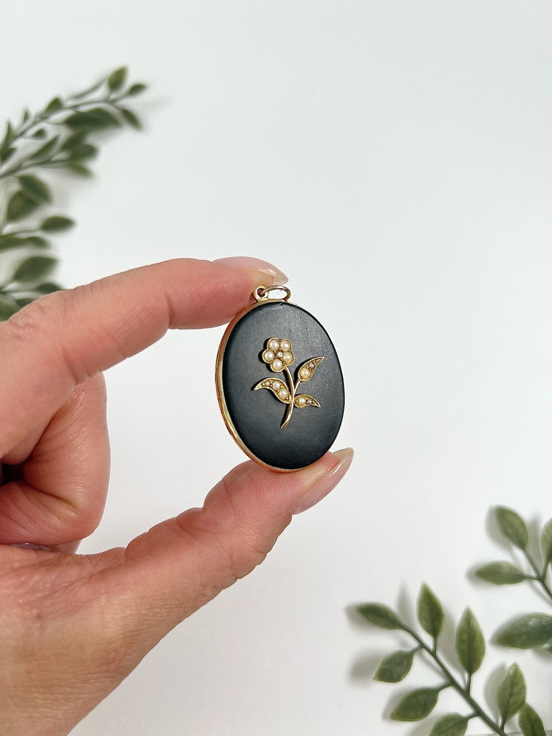 Edwardian 18 Carat Yellow Gold Onyx and Seed Pearl Flower Locket, Circa 1900