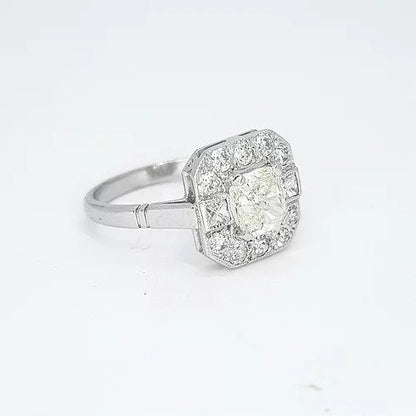 1.03ct Radiant Cut Diamond Cluster Ring; radiant cut diamond surrounded by a halo of diamonds which is accented by square princess-cut diamonds to the shoulders and completed by round-cut diamonds, in 18ct white gold