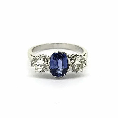 Sapphire and Diamond Three Stone Ring; central 1.40 carat oval-cut sapphire flanked by 0.95cts brilliant-cut diamonds, in platinum